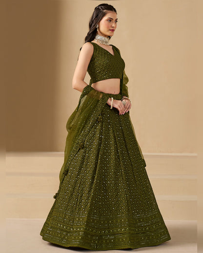 Woman wearing a green traditional outfit with a beige background