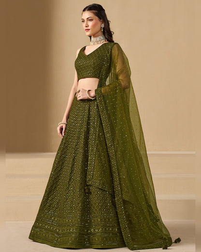 Woman wearing a green traditional outfit with a beige background