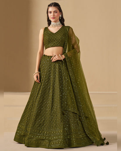 Woman wearing a green traditional outfit with a beige background