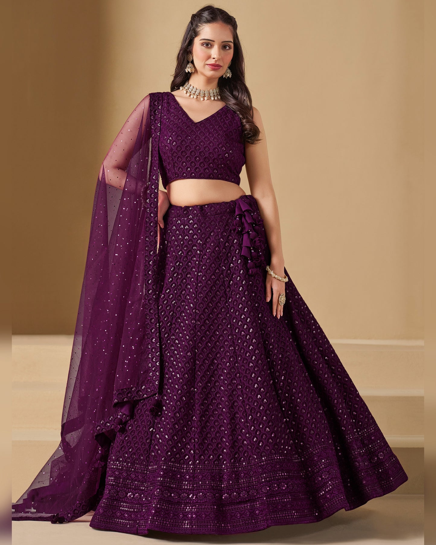 Woman wearing a purple traditional outfit with a beige background