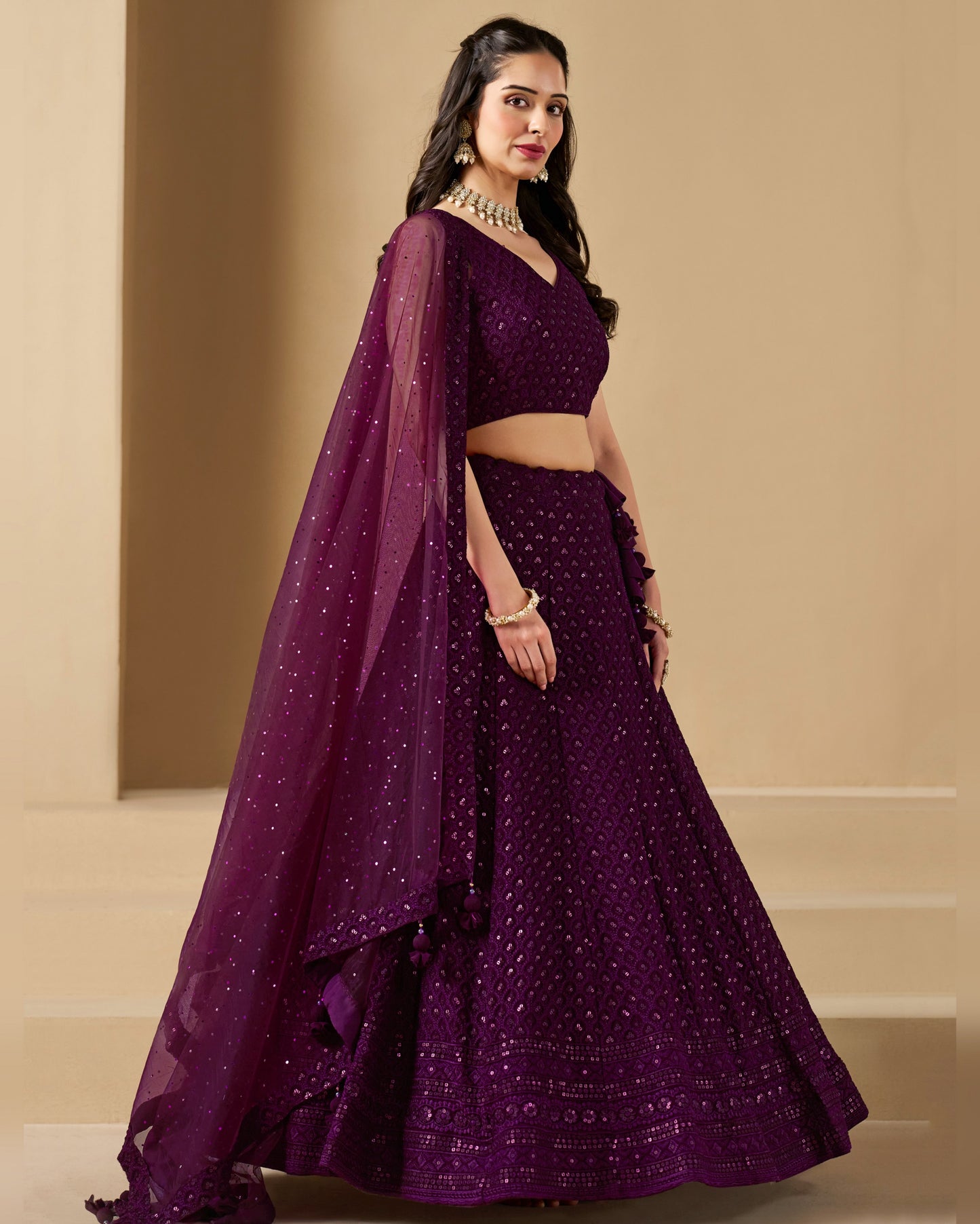 Woman wearing a purple traditional outfit with a beige background