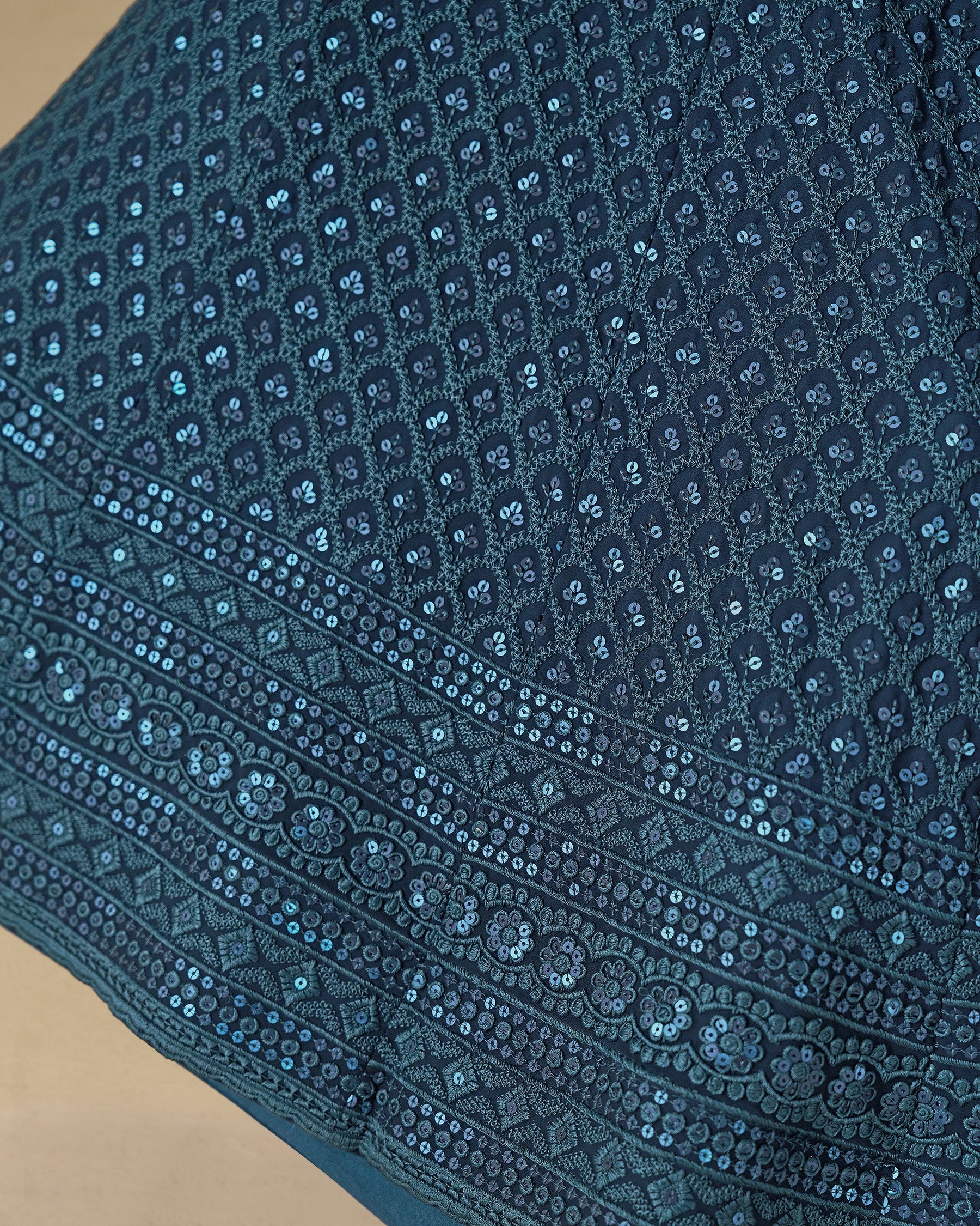 Close-up of a blue embroidered fabric with intricate patterns