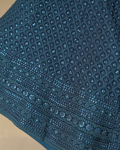 Close-up of a blue embroidered fabric with intricate patterns