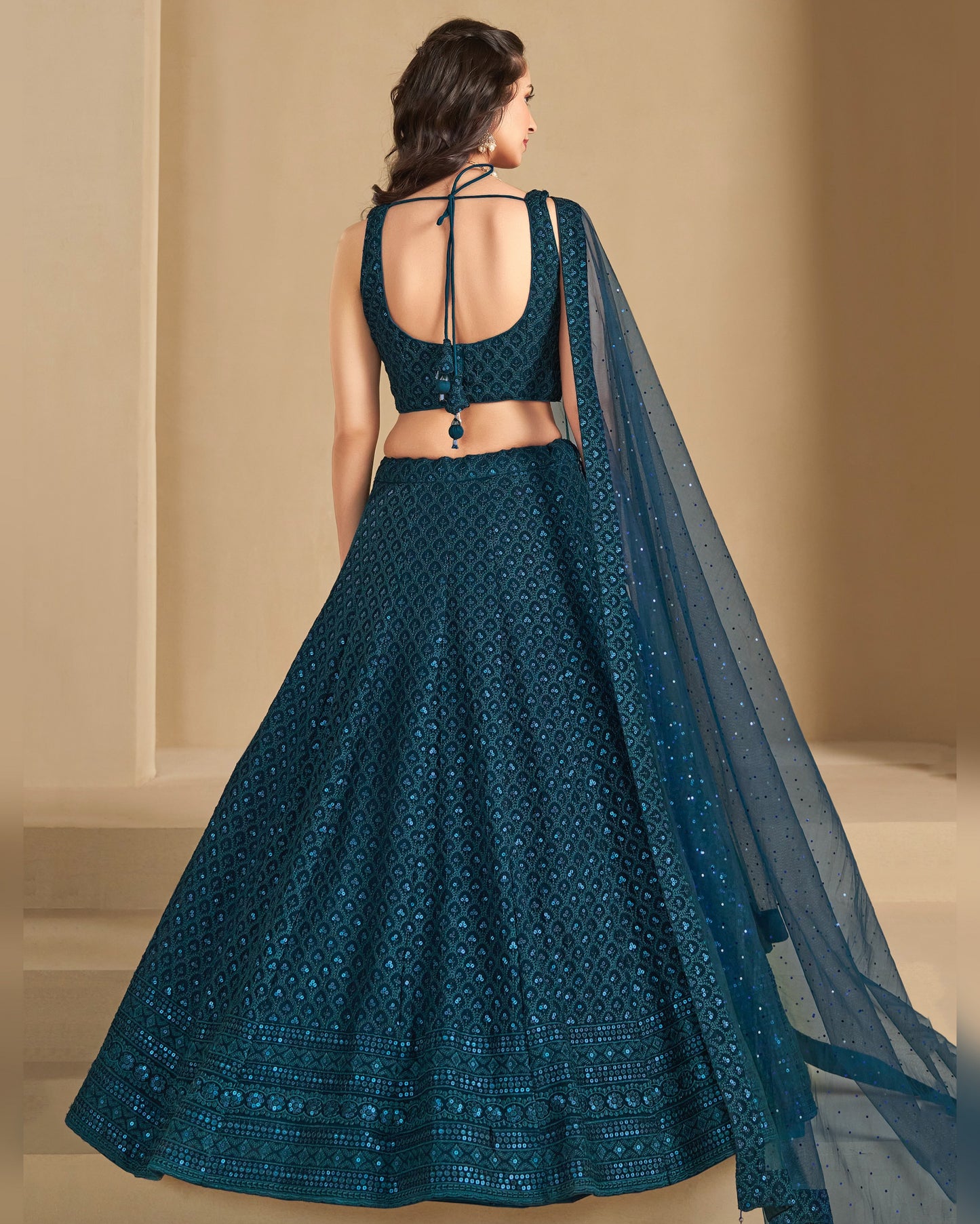 Teal embroidered lehenga with a matching dupatta on a neutral background