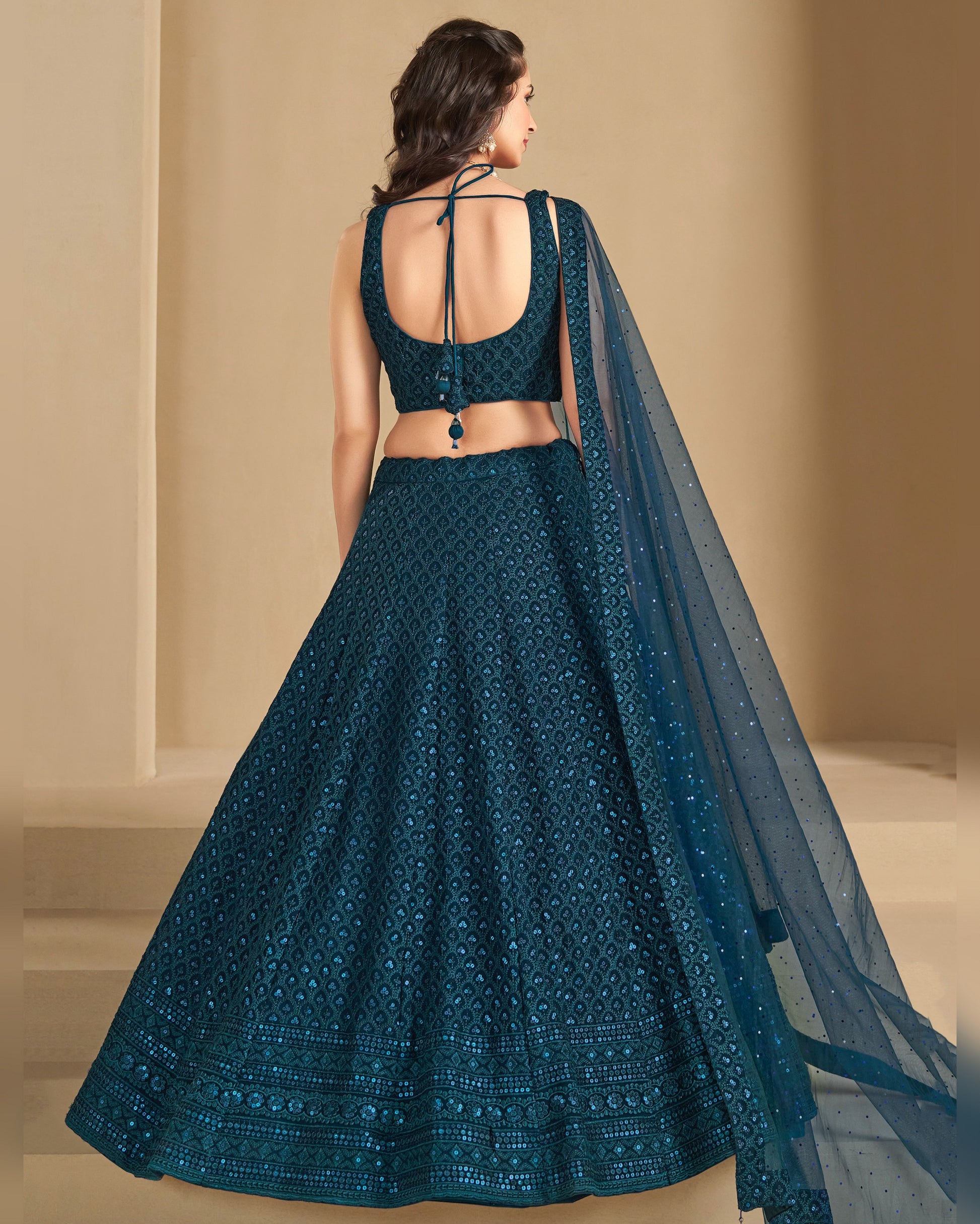 Teal embroidered lehenga with a matching dupatta on a neutral background