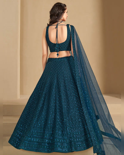 Teal embroidered lehenga with a matching dupatta on a neutral background