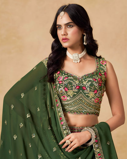 Woman wearing a green embroidered traditional outfit with jewelry on a beige background
