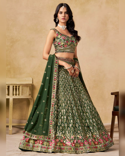 Woman wearing a green embroidered traditional outfit with a beige background