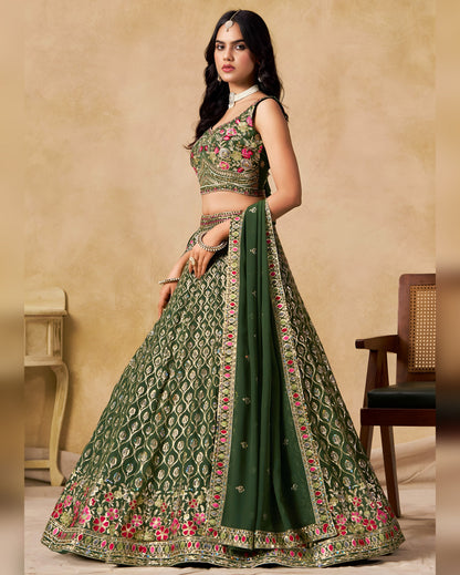 Woman wearing a green embroidered traditional outfit with a beige background