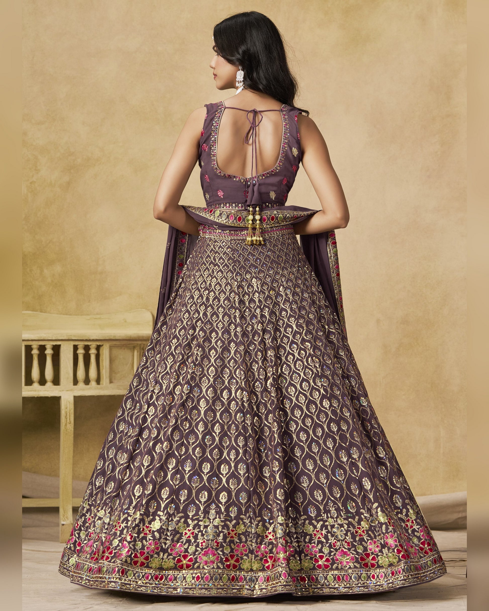 Woman wearing a patterned dress with a beige background