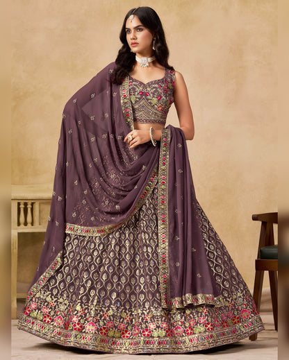 Woman wearing a traditional outfit with a purple dupatta on a beige background