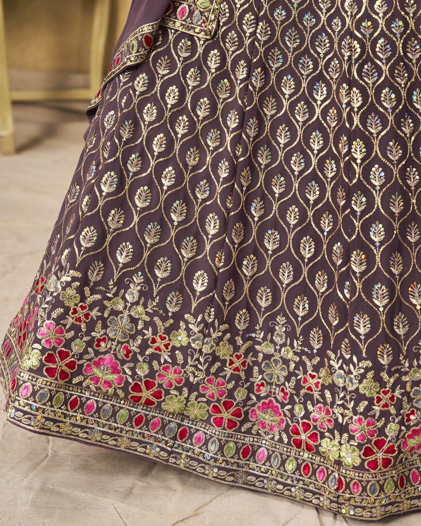Close-up of a dark fabric with floral embroidery on a light background