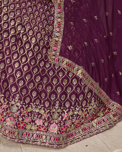 Close-up of a purple embroidered fabric with floral patterns on a light background