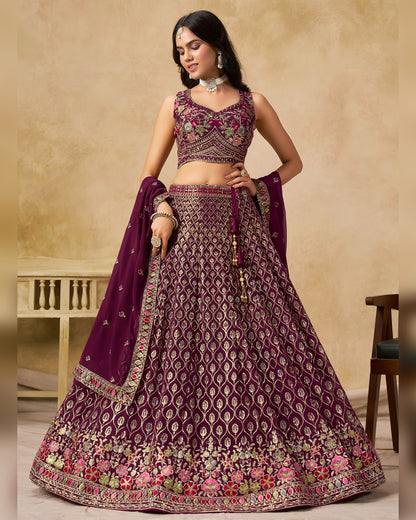 Woman wearing a traditional purple and gold embroidered lehenga with a matching dupatta.