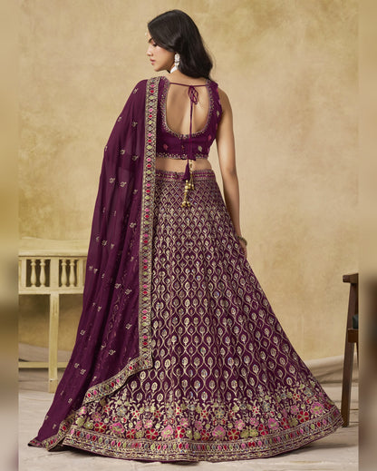 Woman wearing a purple embroidered traditional outfit with a beige background