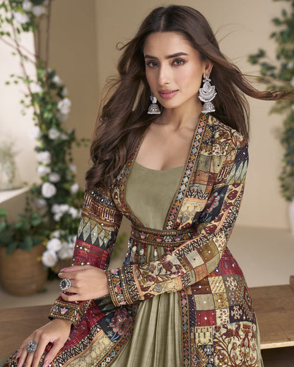 Woman wearing a patterned jacket and green top in an indoor setting with plants.