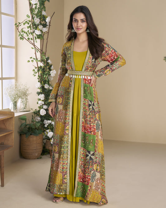 Woman wearing a colorful patterned dress with a yellow top in a room with decorative plants.