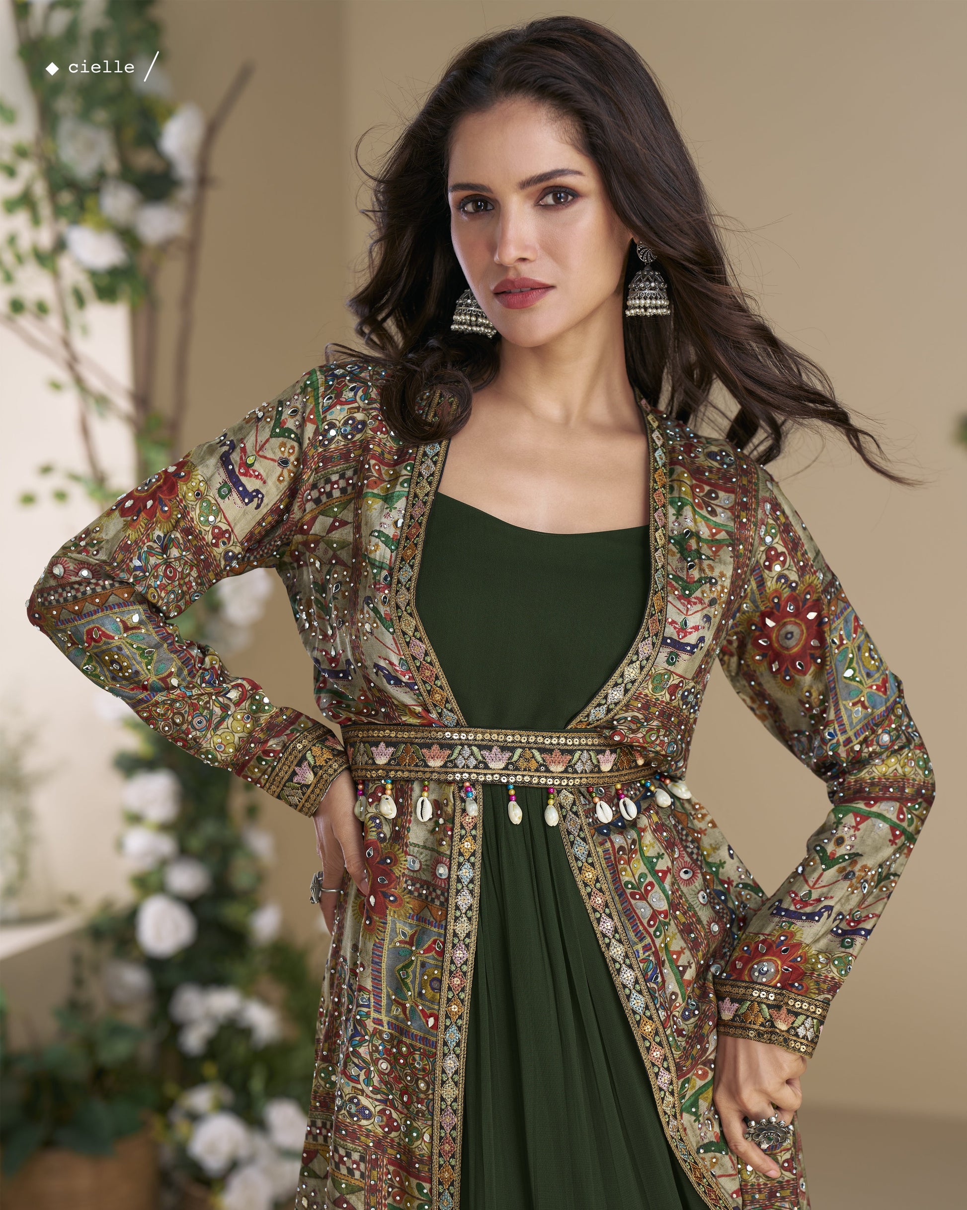 Woman wearing a patterned jacket over a green dress with decorative elements.