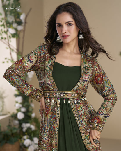 Woman wearing a patterned jacket over a green dress with decorative elements.