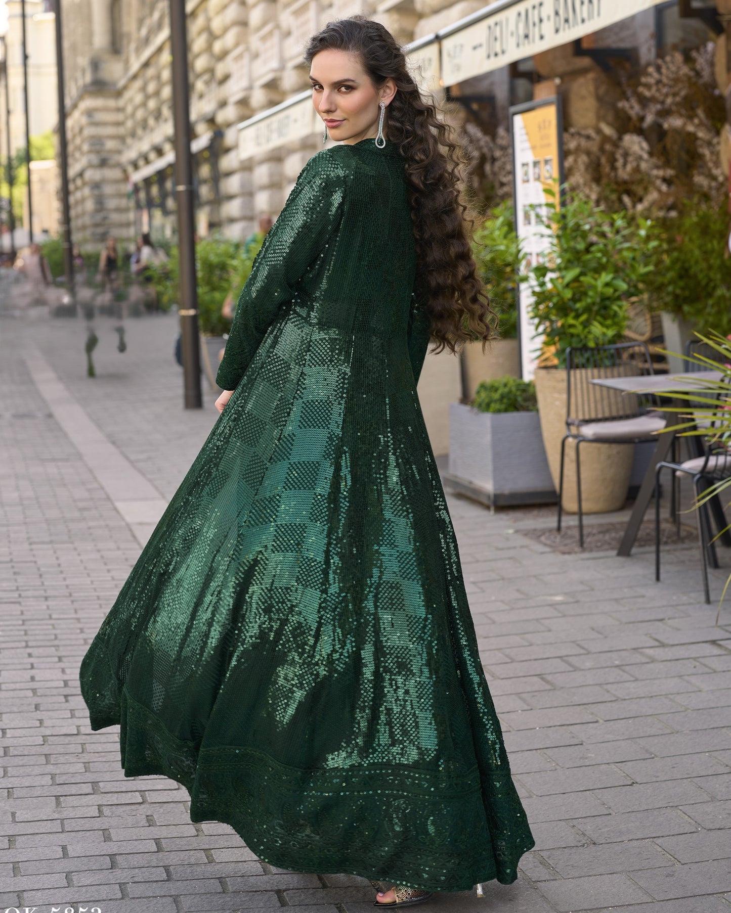 Woman in a green dress walking on a city street