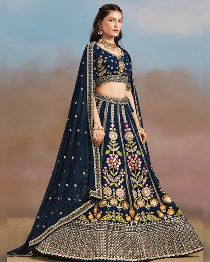 Woman wearing a dark blue embroidered traditional outfit with a blurred background