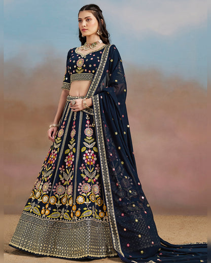 Woman wearing a traditional navy blue embroidered lehenga with a blurred background