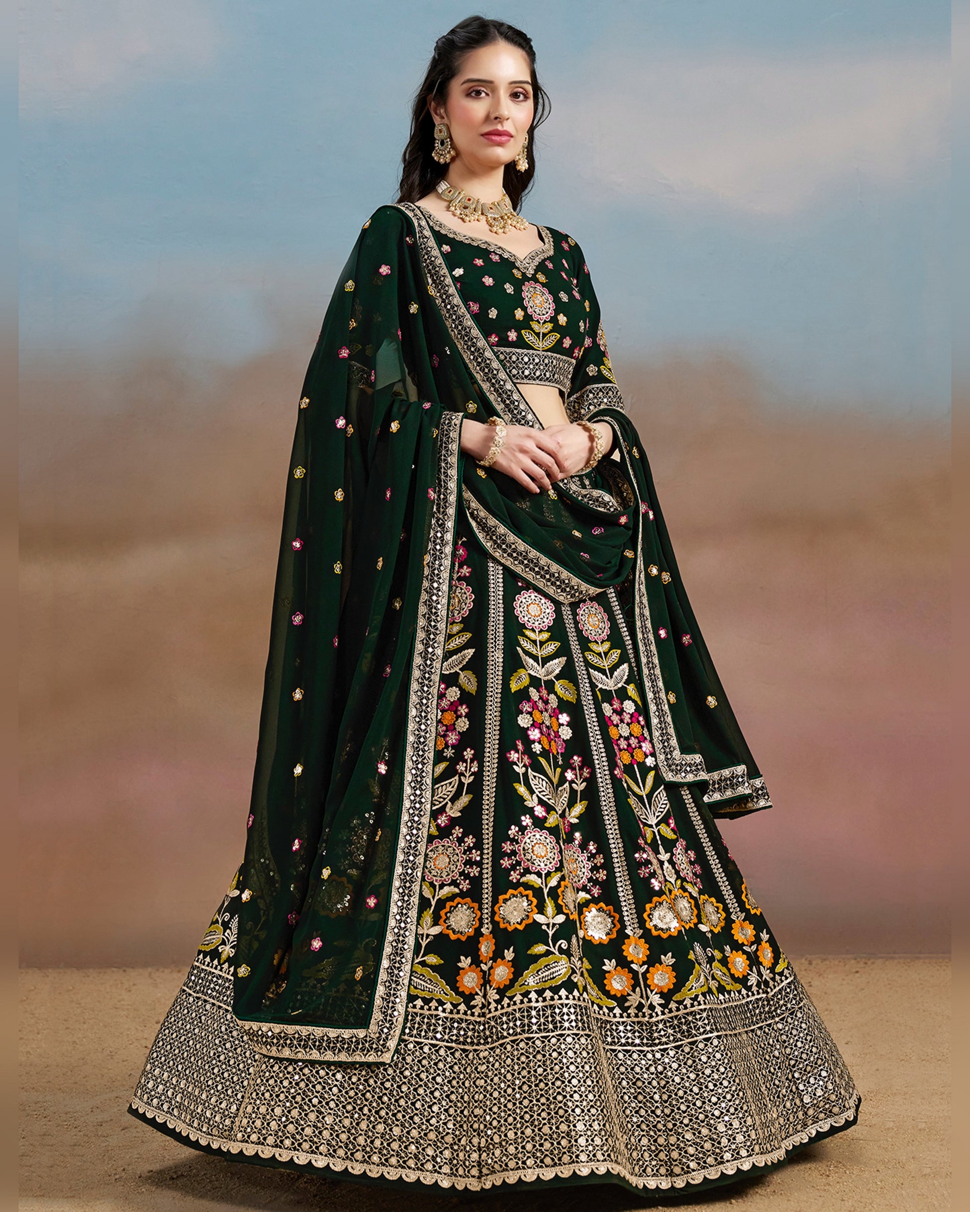 Woman wearing a dark green embroidered traditional outfit with a blurred background