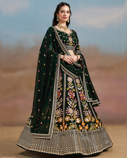 Woman wearing a dark green embroidered traditional outfit with a blurred background
