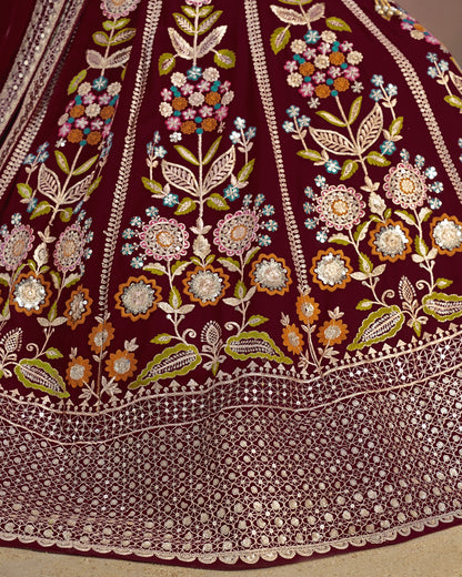 Close-up of a maroon fabric with intricate floral embroidery