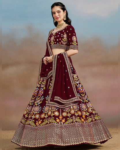 Woman wearing a maroon embroidered traditional outfit with a blurred natural background