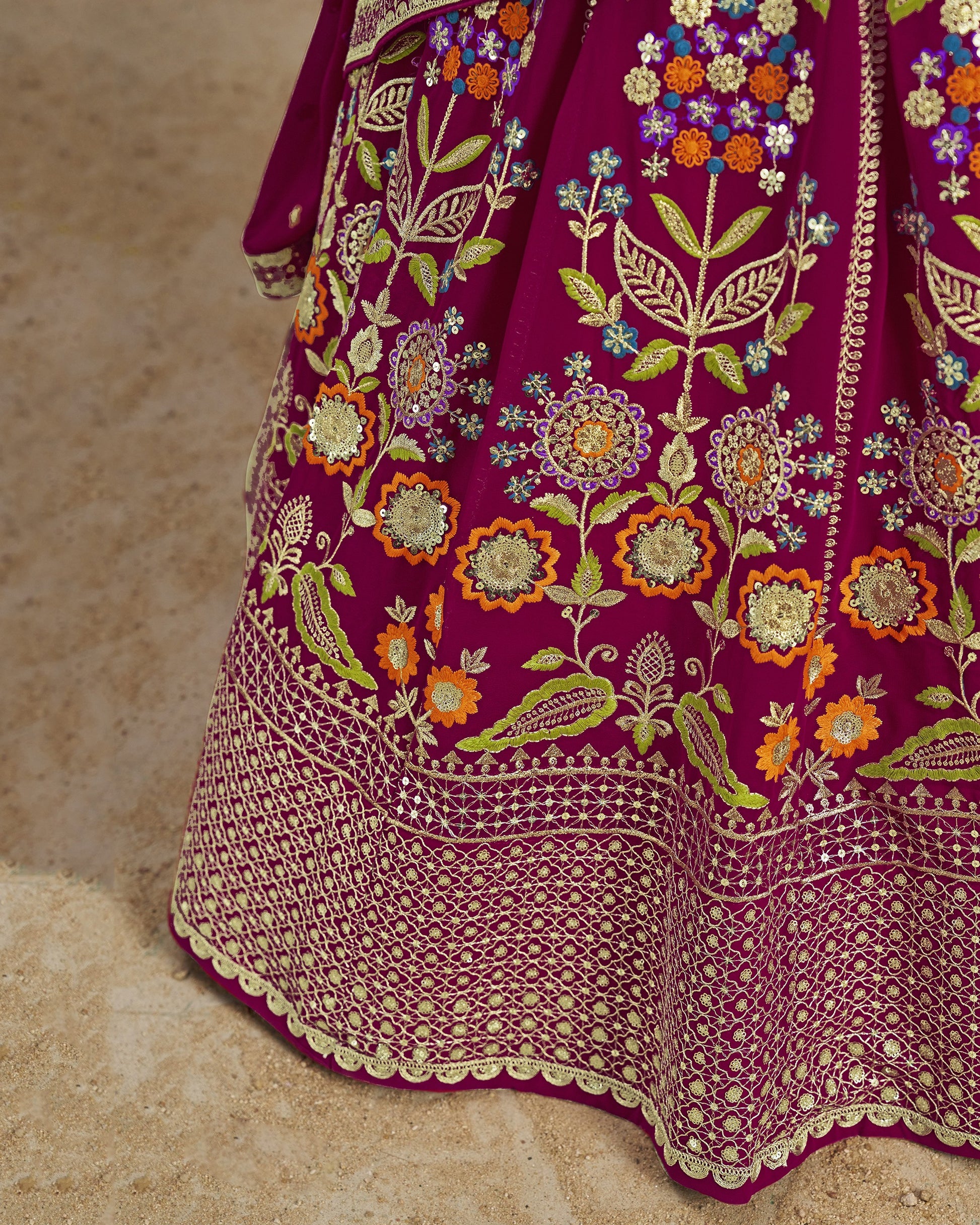 Close-up of a purple embroidered fabric with floral patterns on a beige background