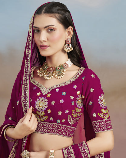 Woman wearing a traditional purple embroidered outfit with jewelry against a blurred natural background