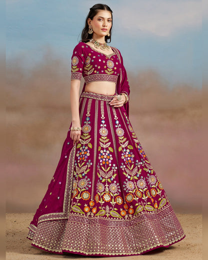 Woman wearing a traditional embroidered pink lehenga with a blurred background
