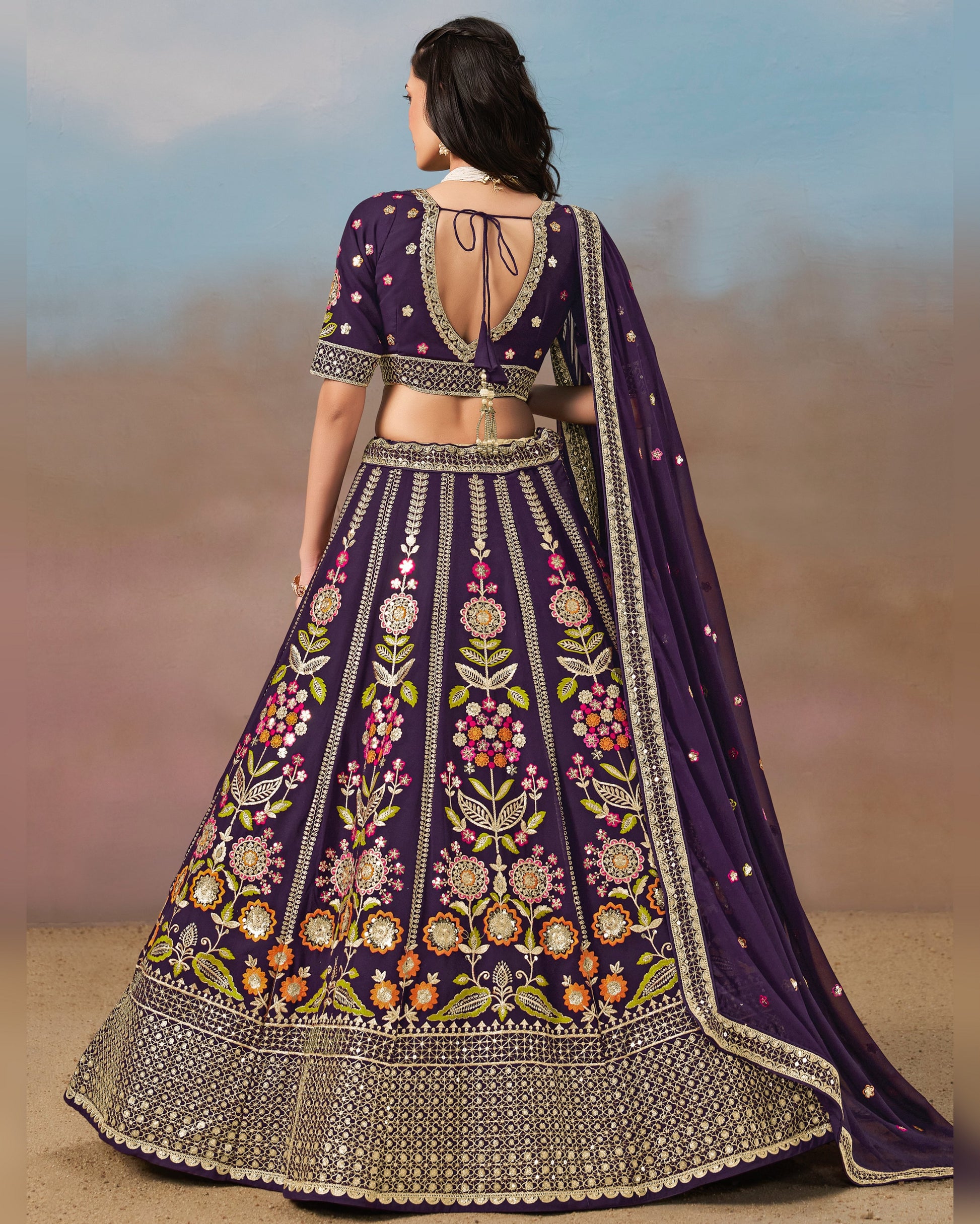 Woman wearing a purple embroidered traditional outfit with a blurred background