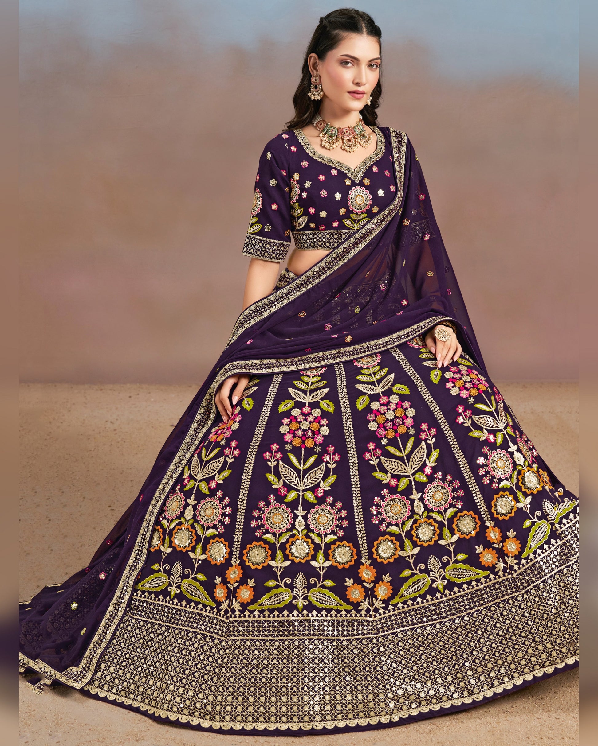 Woman wearing a purple embroidered traditional outfit with a plain background