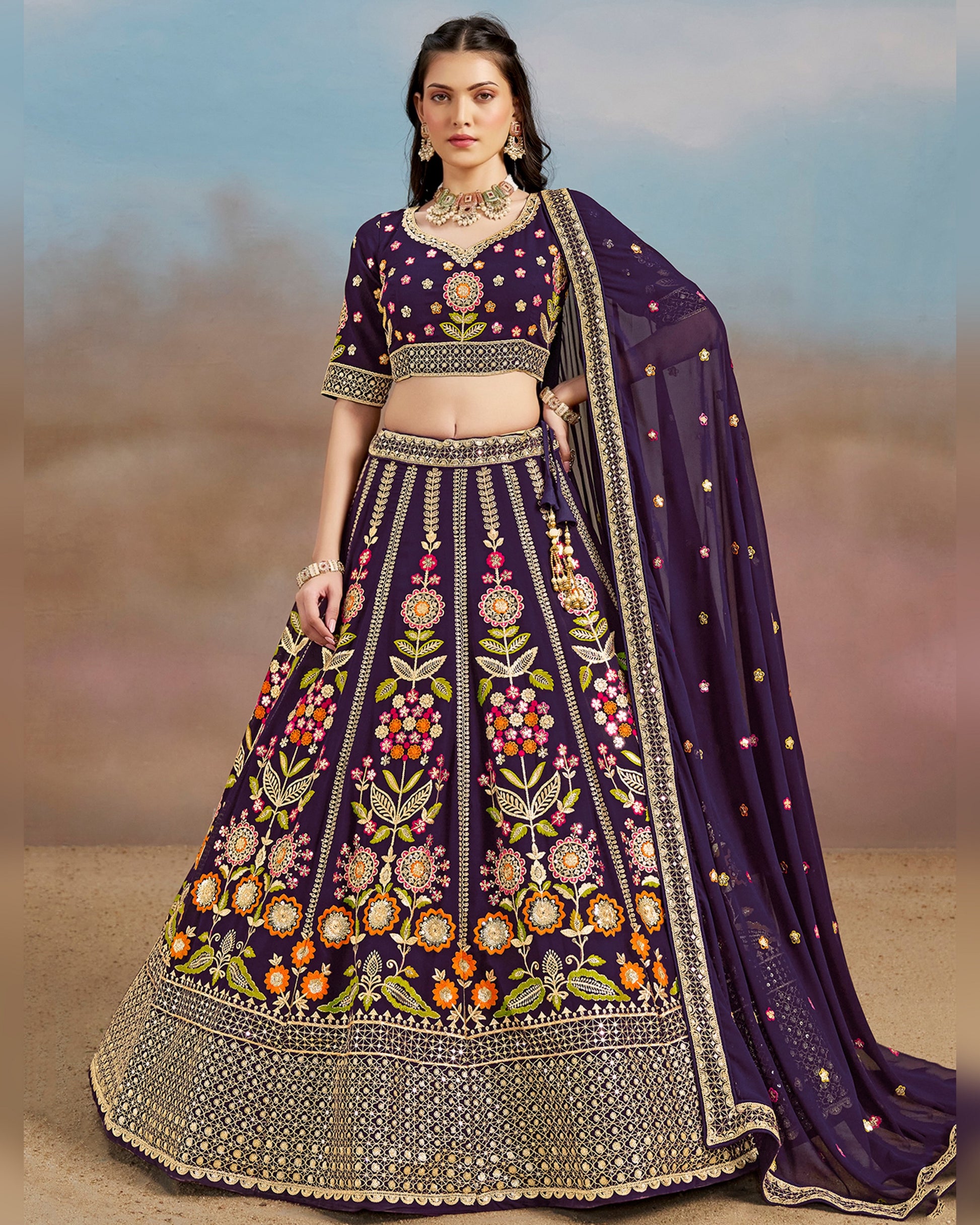 Woman wearing a traditional embroidered purple lehenga with a blurred background