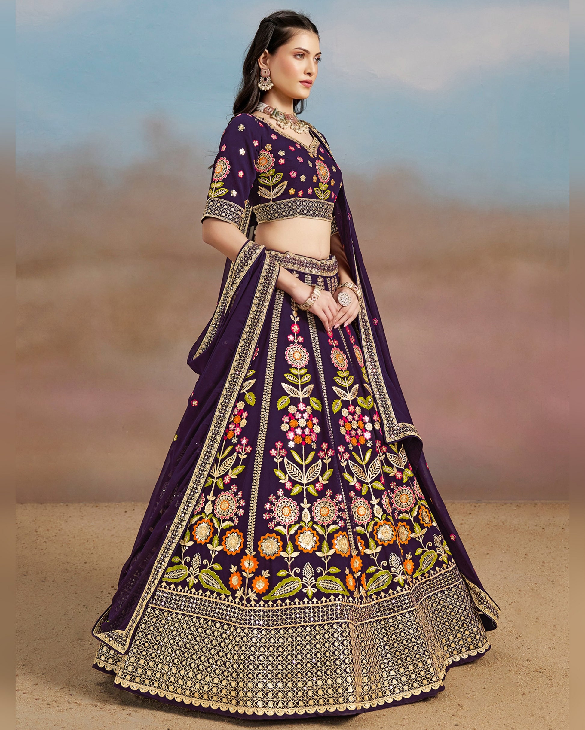 Woman wearing a traditional embroidered purple lehenga with a blurred background