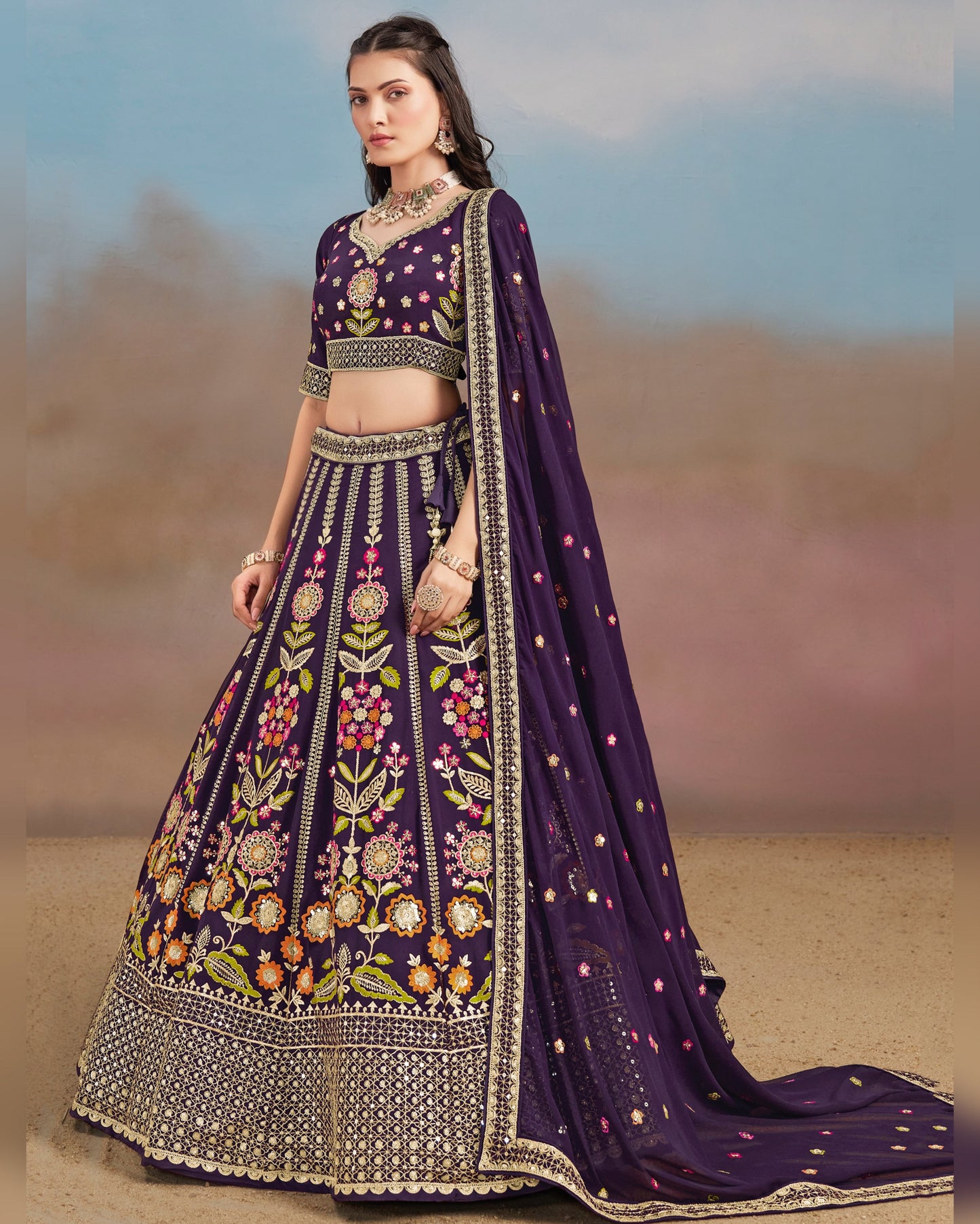 Woman wearing a purple embroidered traditional outfit with a blurred desert background