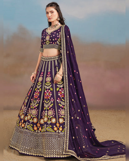 Woman wearing a purple embroidered traditional outfit with a blurred desert background