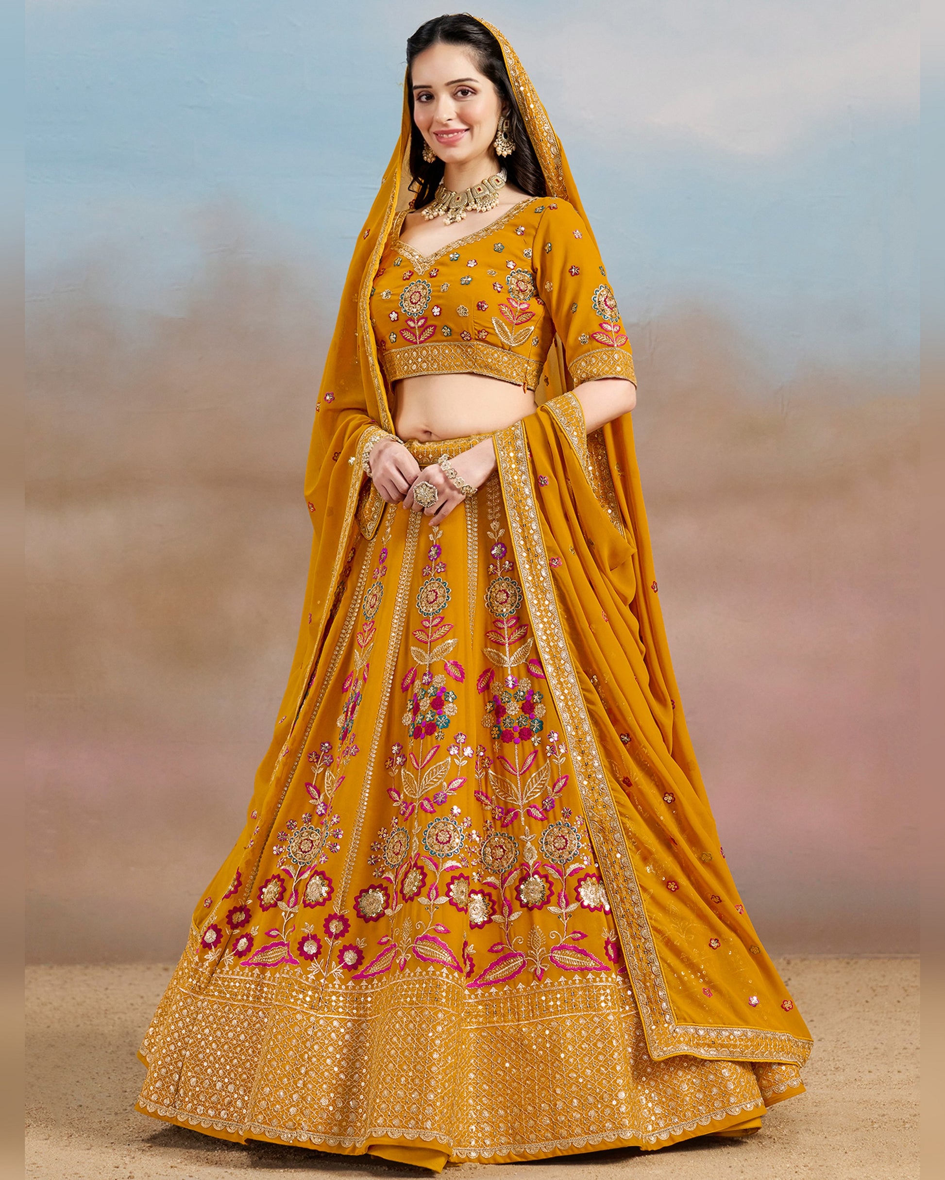 Woman wearing a yellow embroidered traditional outfit with a blurred background