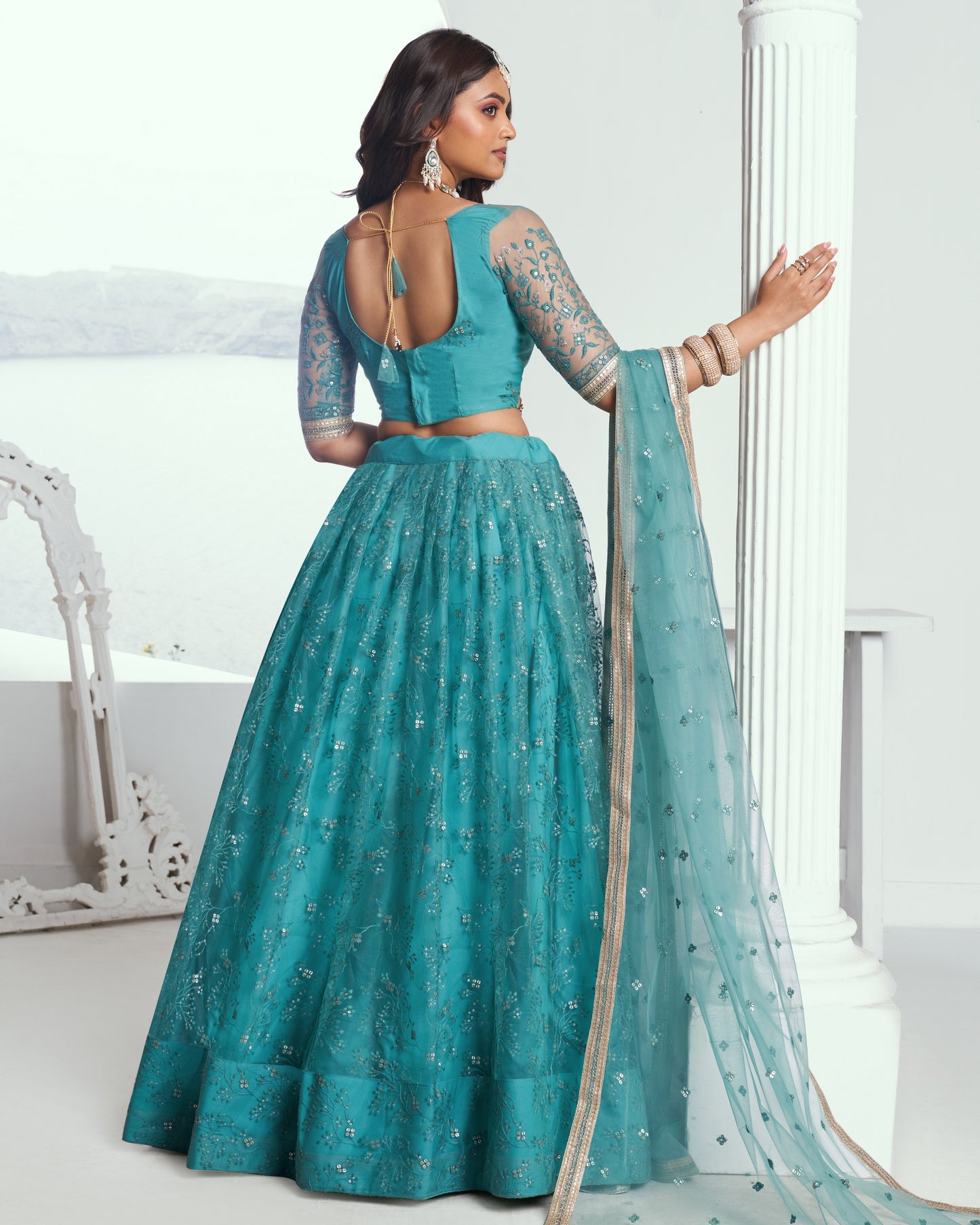 Teal traditional outfit with a matching dupatta on a white background
