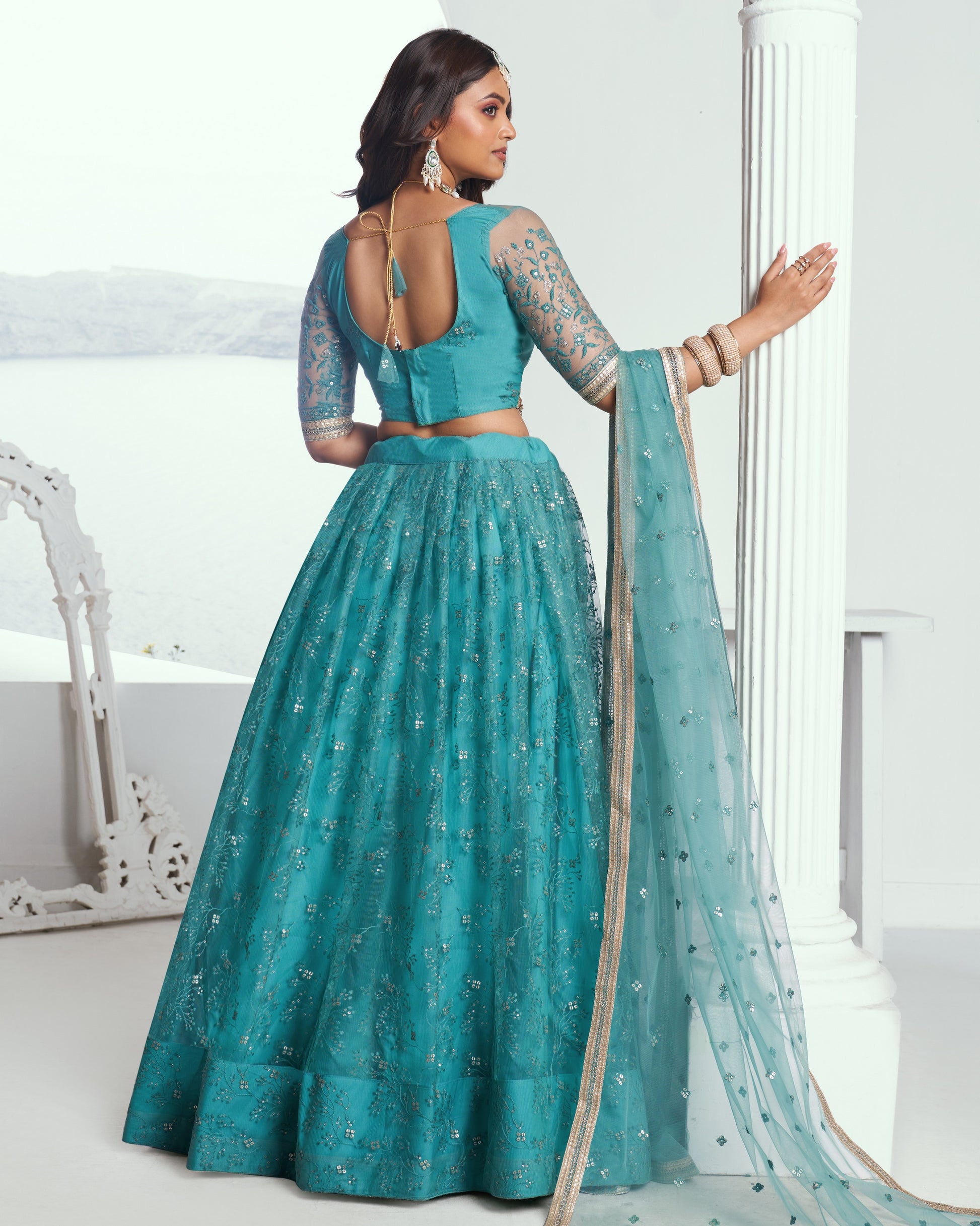 Teal traditional outfit with a matching dupatta on a white background