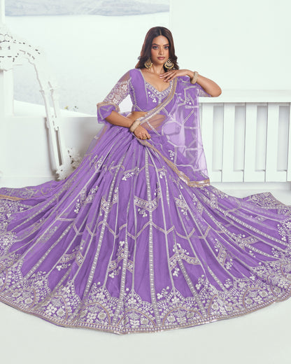 Woman wearing a purple embroidered saree with a white background