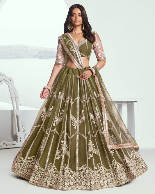 Woman wearing a green embroidered traditional outfit with a white background