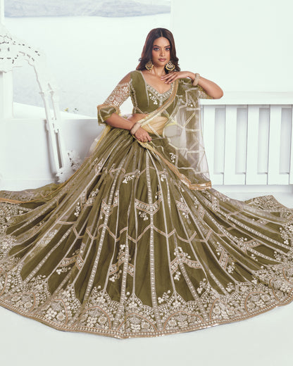 Woman wearing a green embroidered saree with a white background