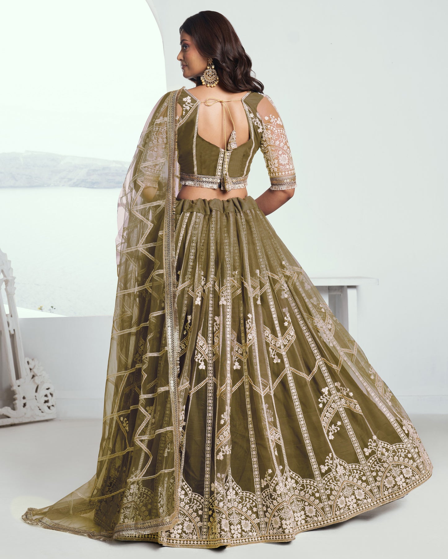 Green embroidered lehenga with a matching blouse on a white background