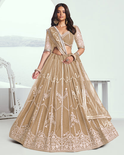 Woman wearing a beige embroidered traditional outfit on a white background