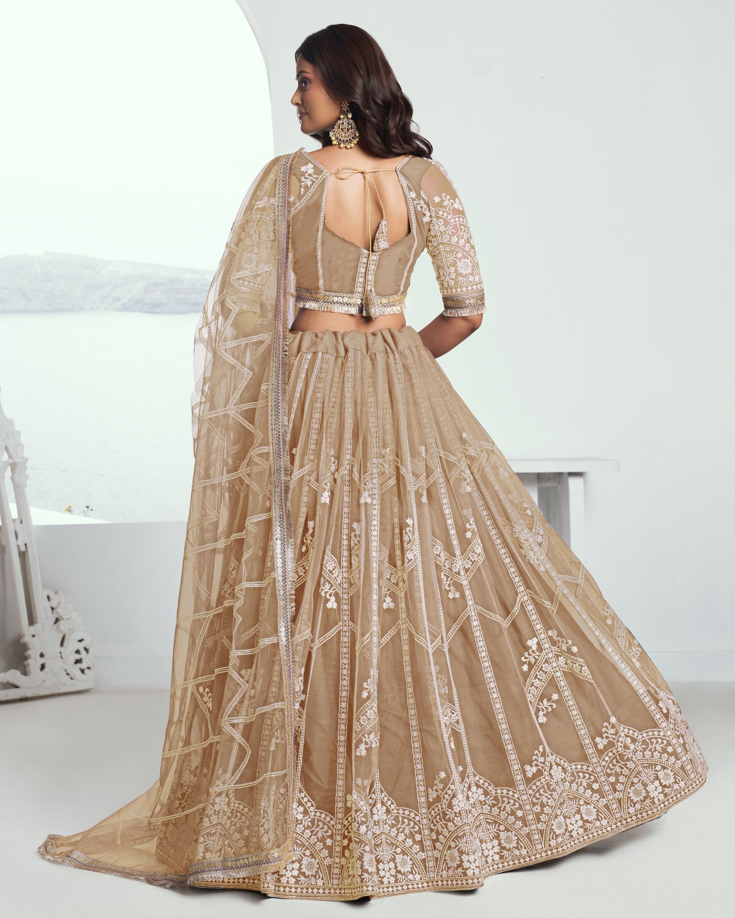 Beige embroidered lehenga with a white background