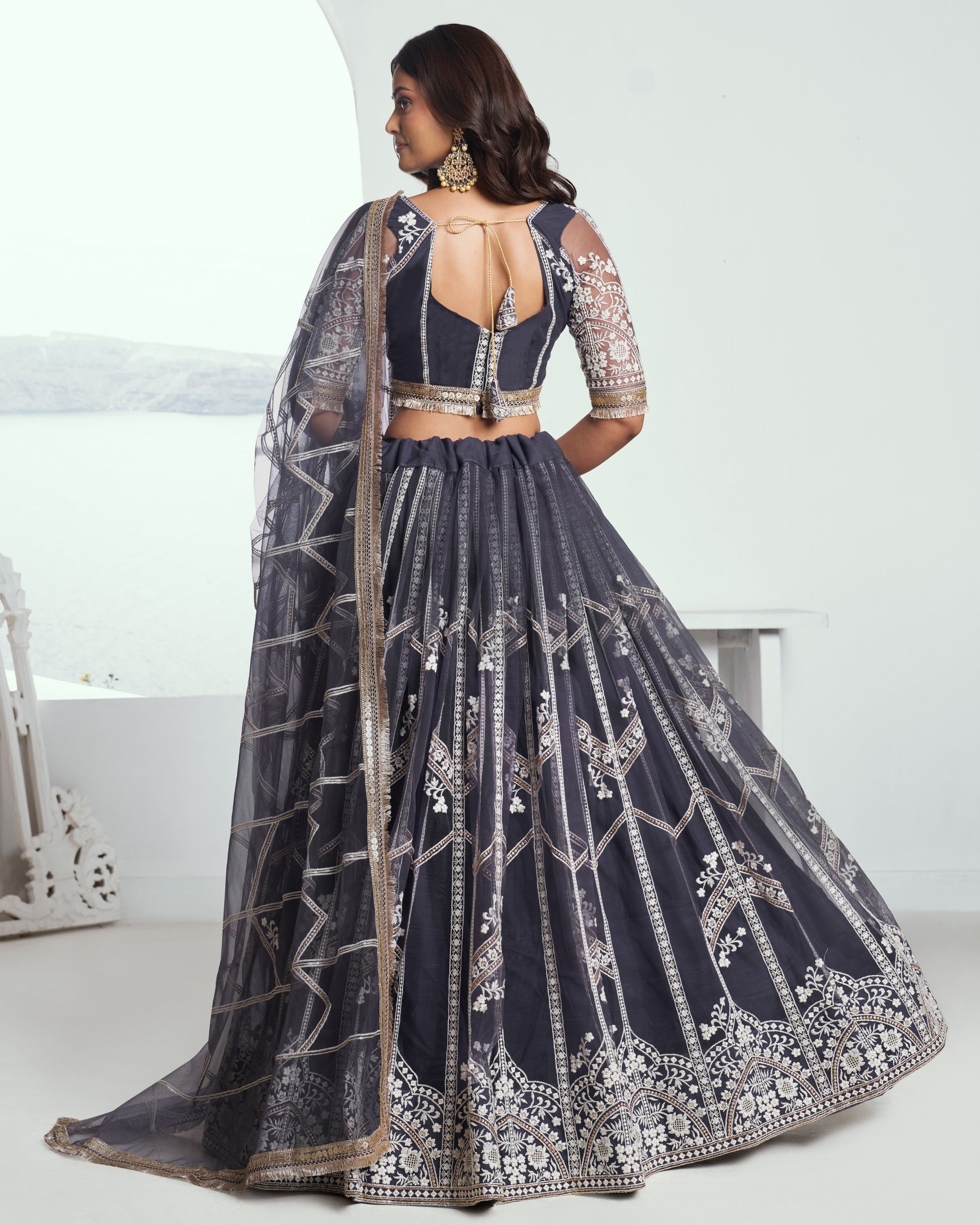 Navy blue embroidered lehenga with silver details on a white background