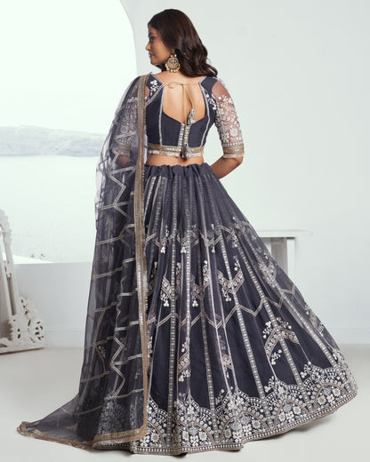 Navy blue embroidered lehenga with silver details on a white background